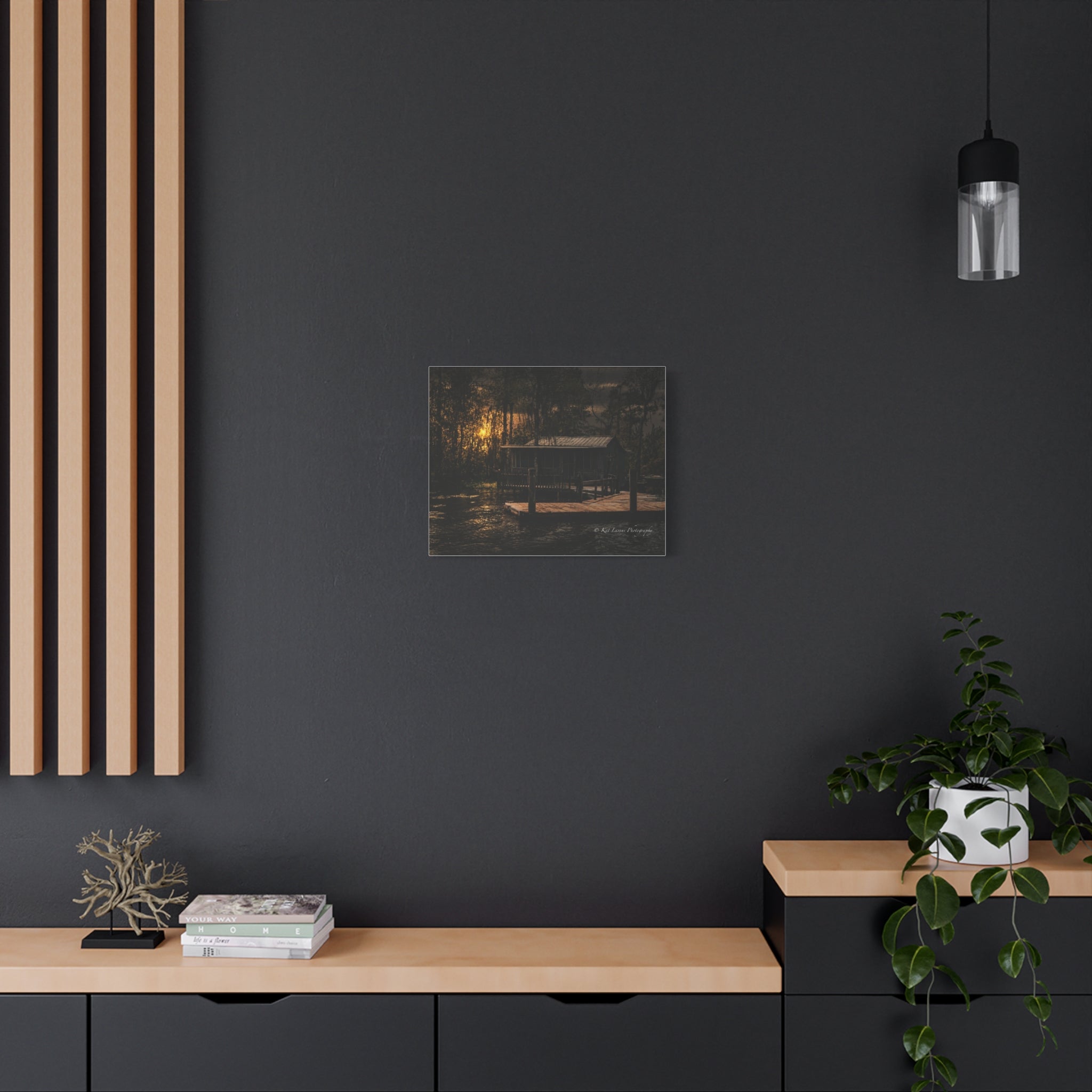 Last Light on the Bayou canvas print displayed in a dark moody interior.