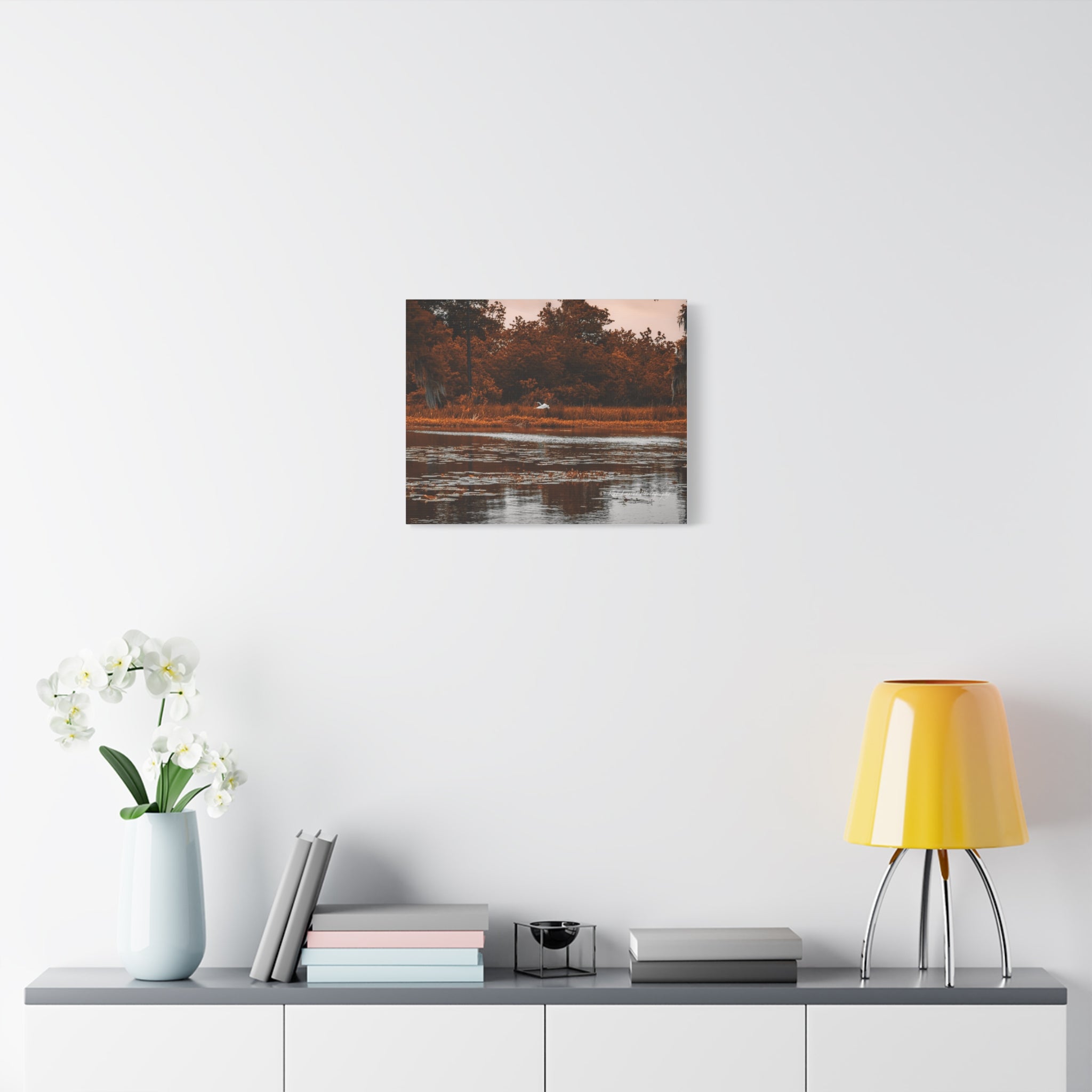 Heron in Amber Light canvas wall art displayed in a bright modern room with neutral decor.